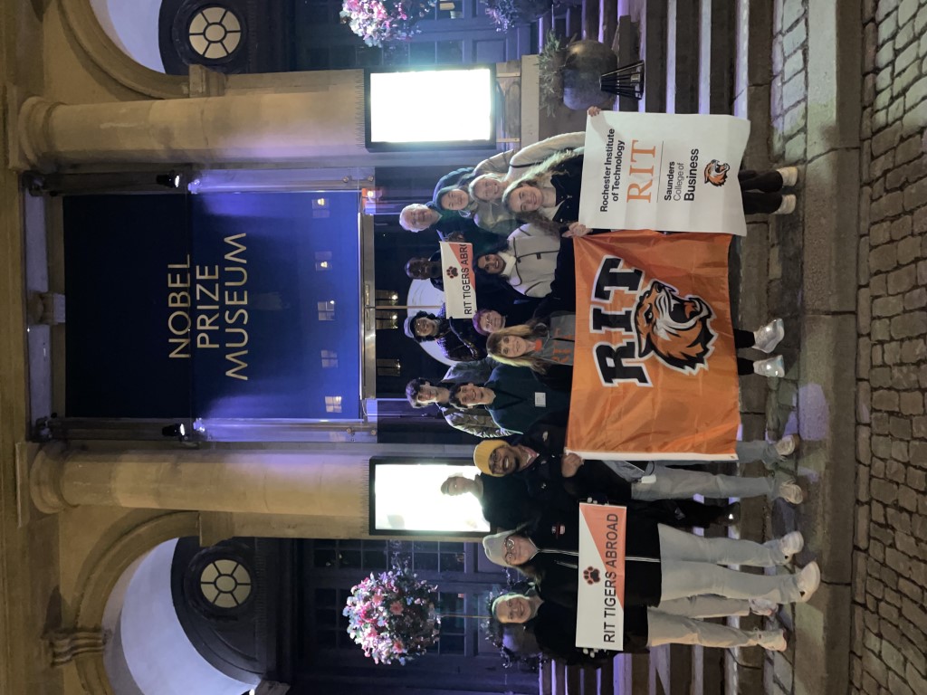 students, along with two Access Services team members, pose in front of the Nobel Prize Museum