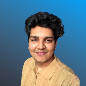 Photo of male student with yellow shirt and blue background