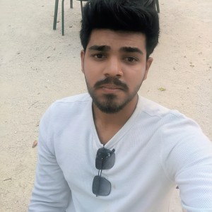 Photo of male student with white shirt and sunglasses hanging