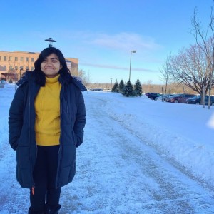 Adya posing for a photo outside during the winter in Rochester, NY.