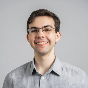 Male student smiling in a gray shirt