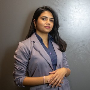 A professional shot of Usha in business formal attire