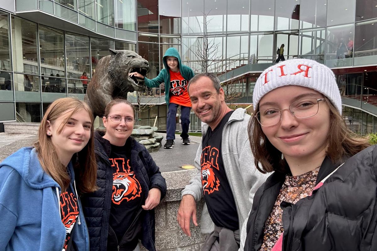 Family with tiger statue