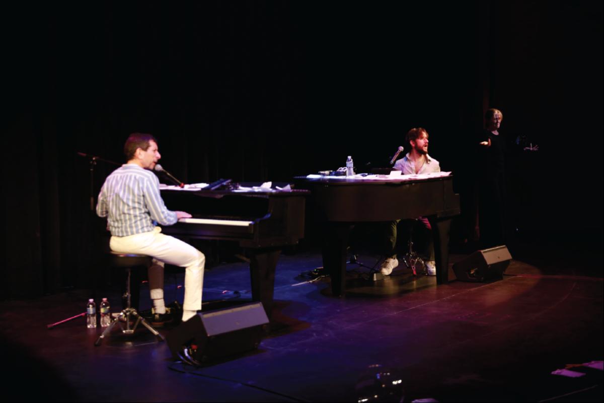 two people playing the piano