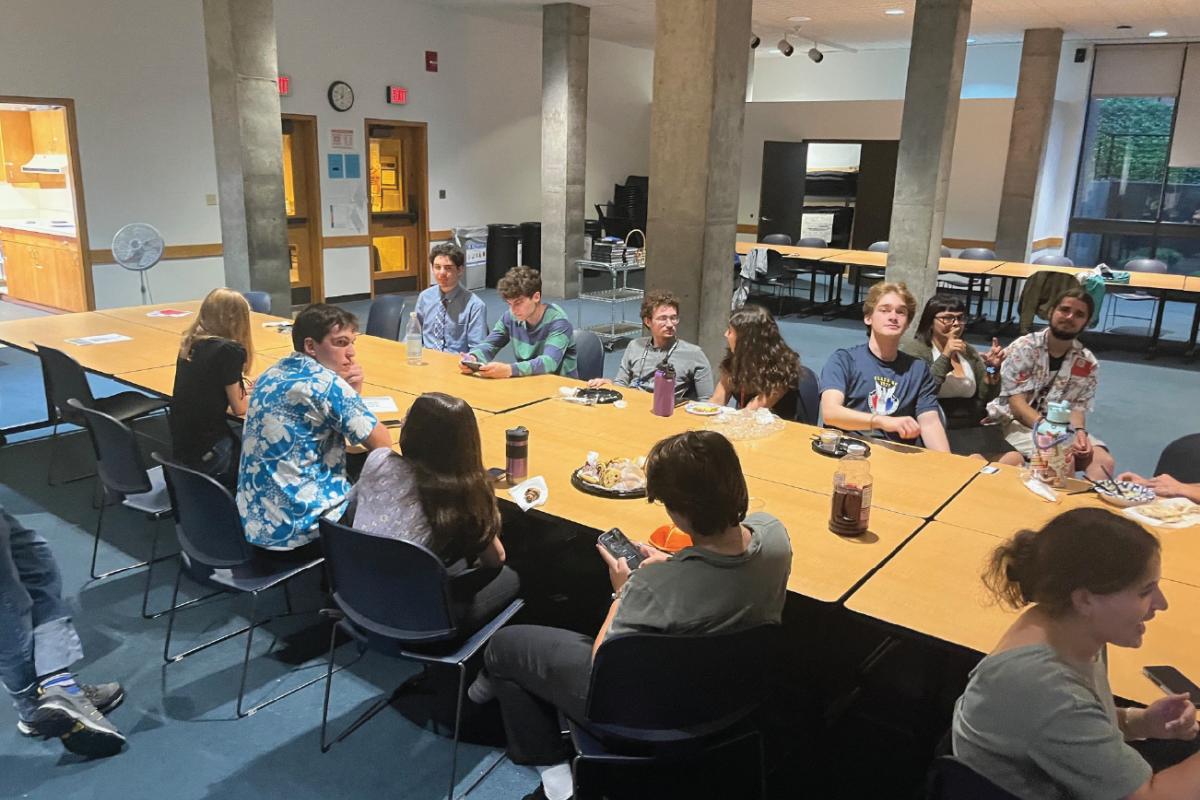 Students and community members gather around tables for a Shabbat dinner hosted by Hillel at RIT.