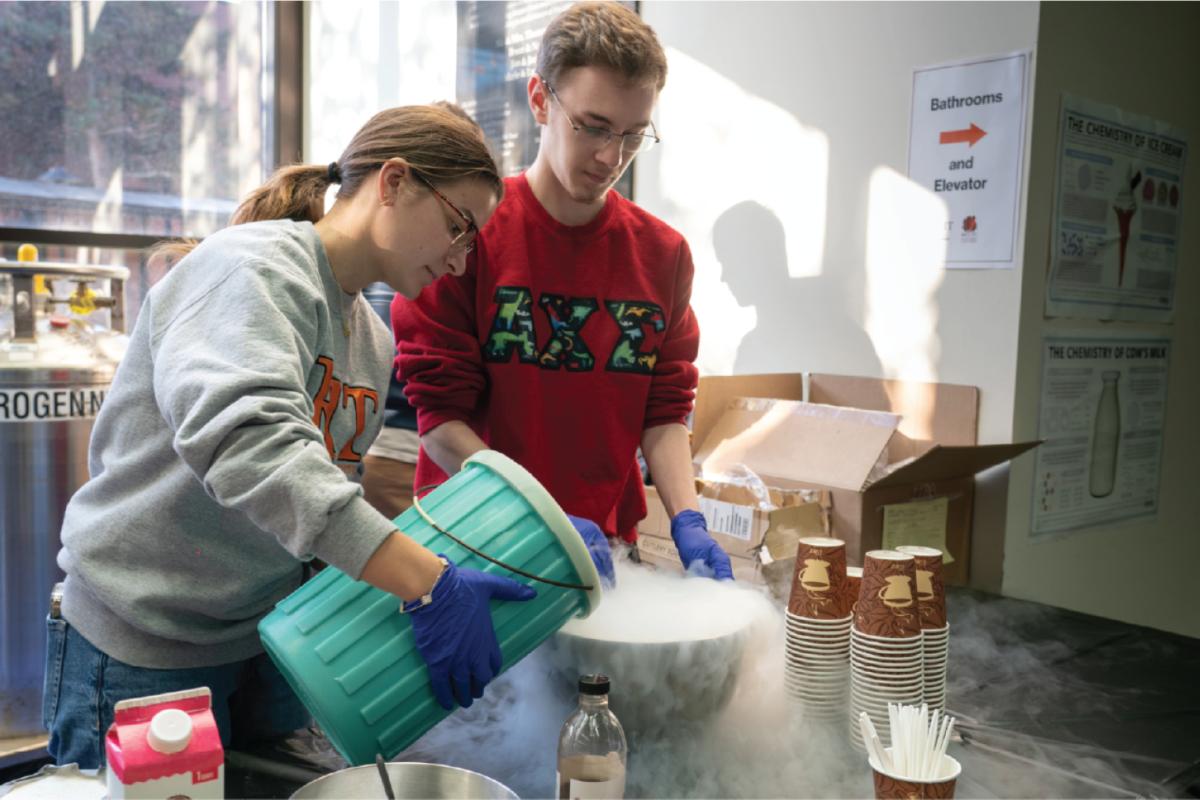 two students pouring liquid nitrogen and doing experiments