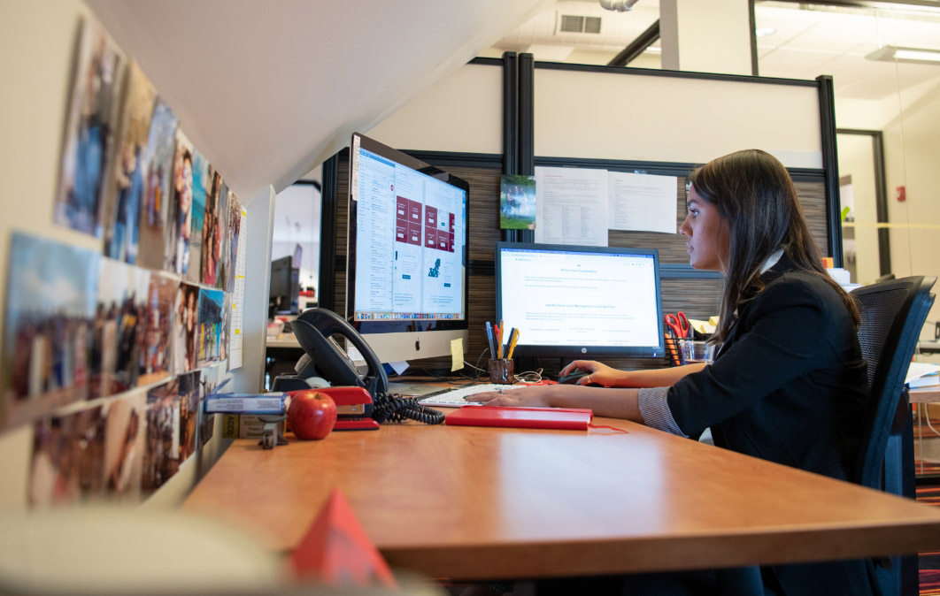 woman looking at her computer in an office environment