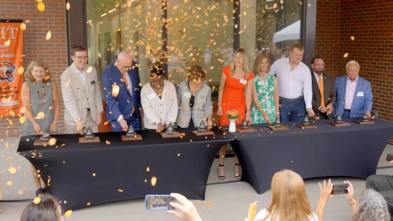 SCB and RIT Leadership ringing bells at the opening