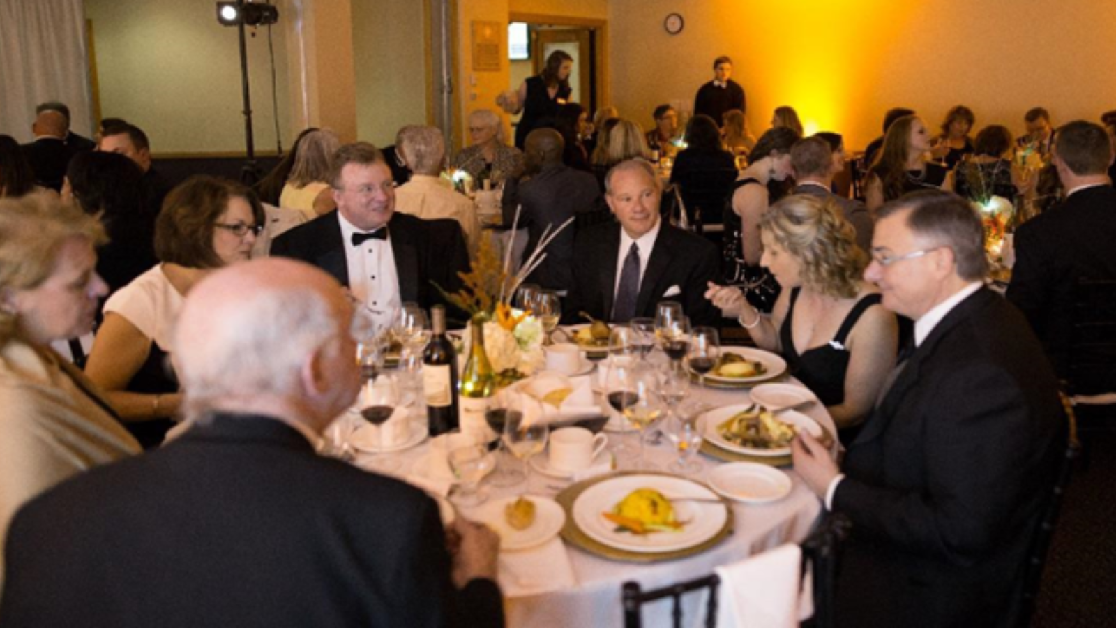 People sitting around a table enjoying dinner