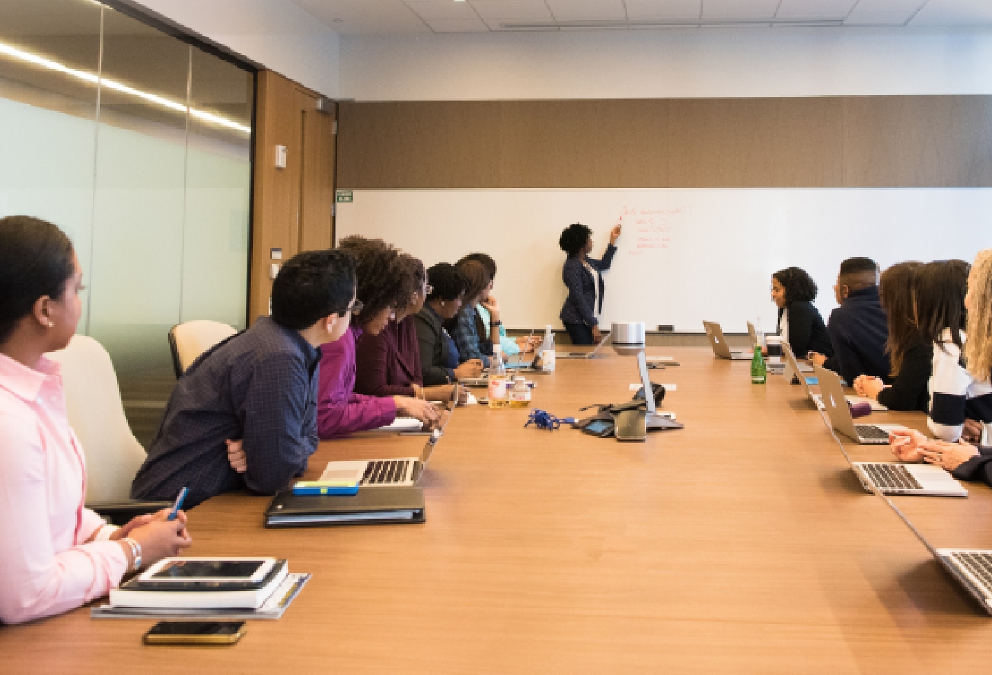 Students watching a professor at a white board