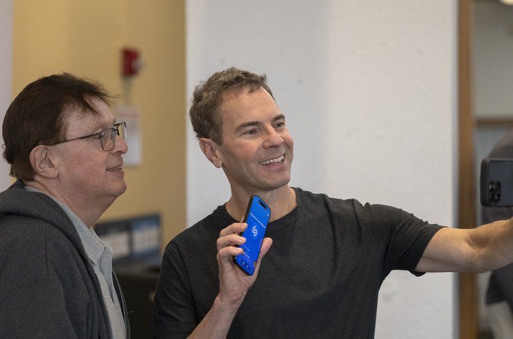 Chris Barton, Founder of Shazam holding a phone with the shazam logo