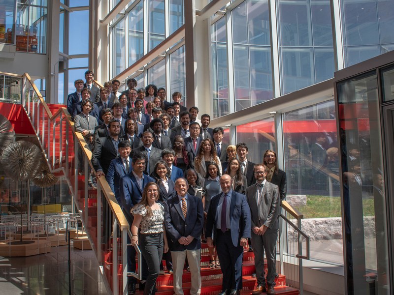 large group of people in business attire standing on staircase