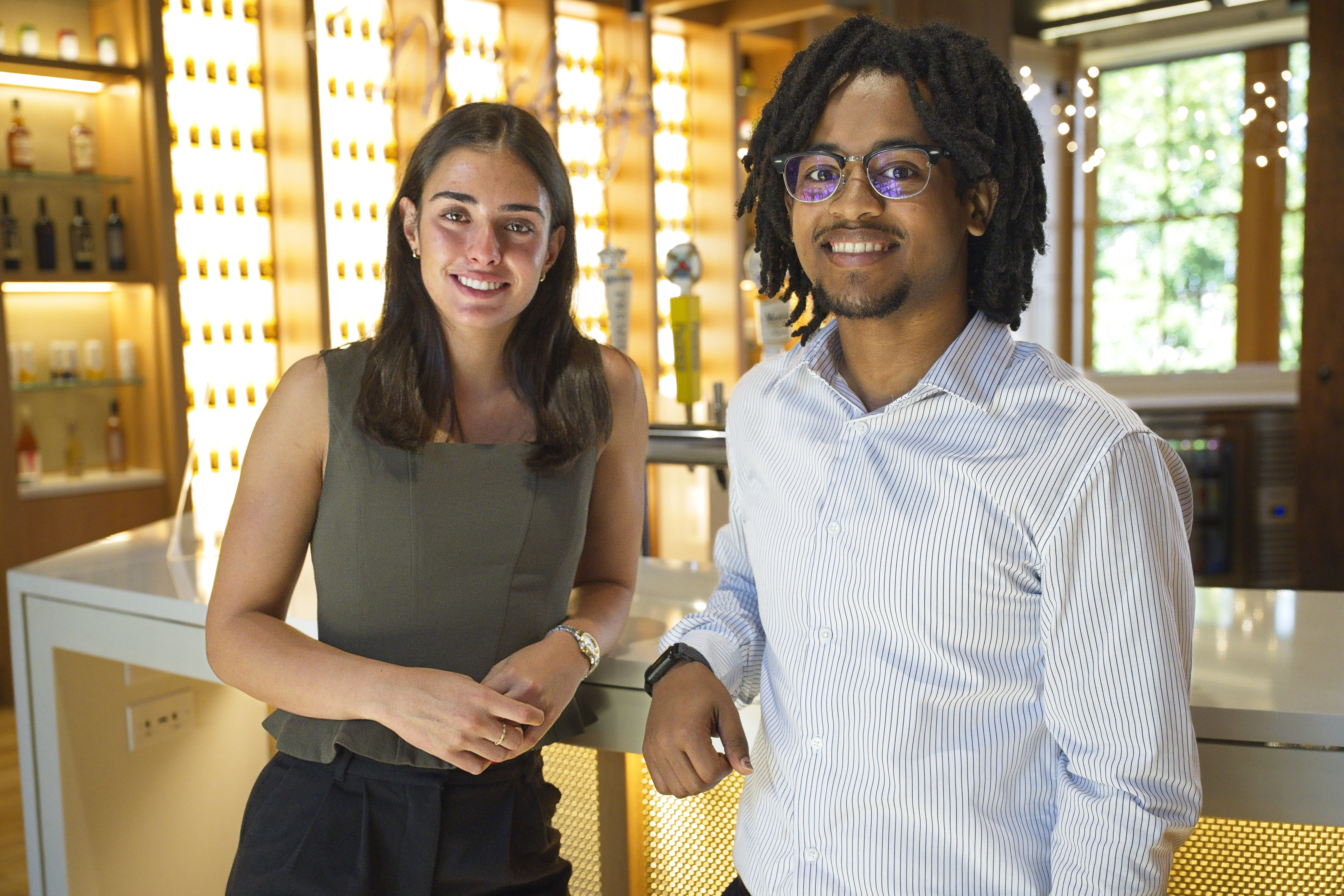 Students talking next to a bar