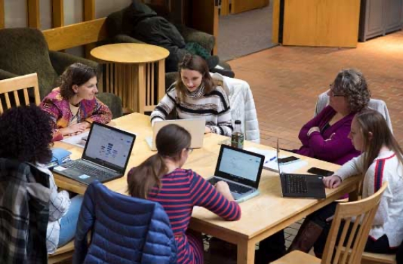 Students sitting around a table in the library