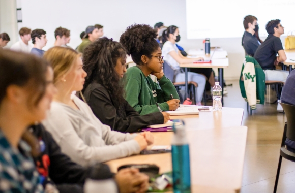 Freshmen students sitting at a table