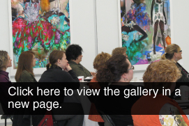Group watching a speaker in an art gallery