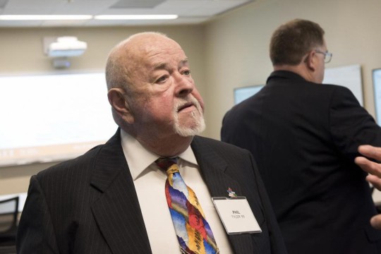 Dr. Philip R. Tyler wearing a suit with a name tag on.