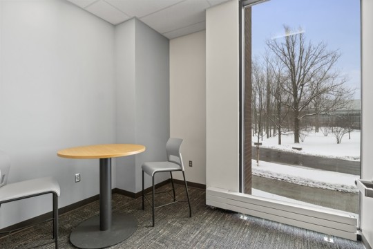 a small meeting room, with a table and two chairs.