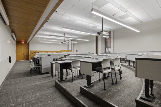 a lecture hall with raised, semi circle seating.