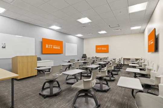 a classroom setting with individual desks and chairs. 