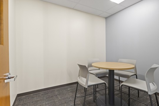 a room with a small round table and chairs.