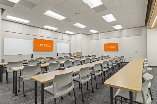 large classroom with long tables and chairs.