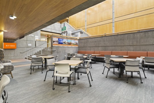 a sunken lounge area with several tables and chairs.