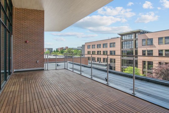 right side view of a terrace space with a wooden floor and railings.