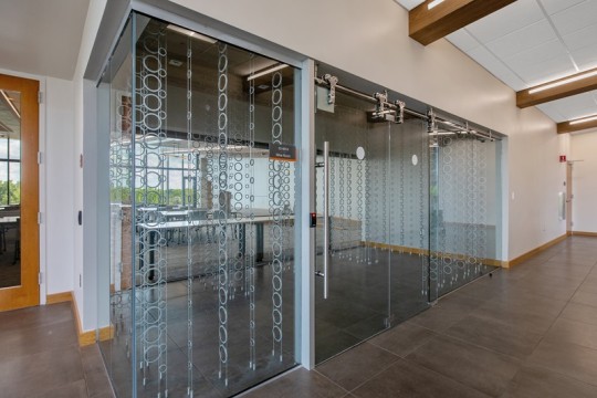 a glass room with holders for wine bottles.