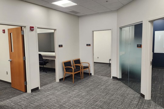 a reception area with several doors leading to other office spaces.