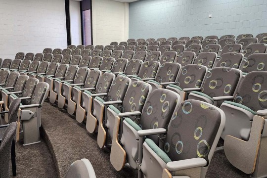 several rows of empty auditorium seating.