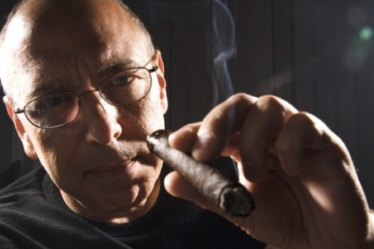 Person posing with rolled paper