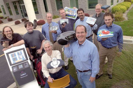 Workers holding up products