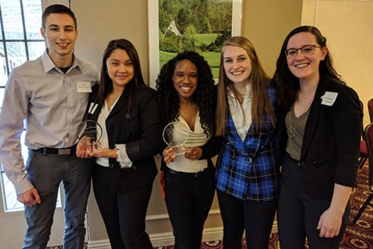 The two winning teams for RIT pose together for a photo.