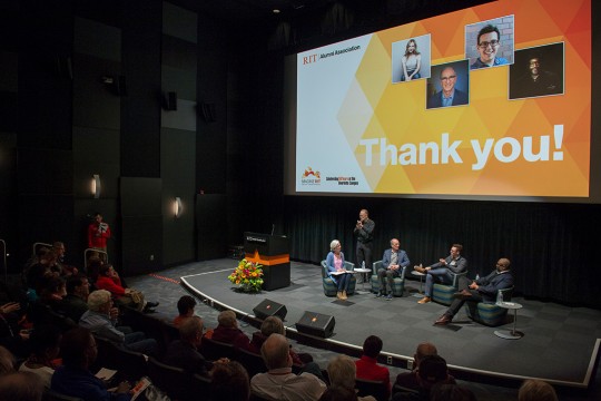 Overhead view of presenters sitting on stage.