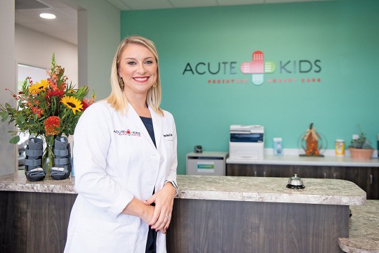 Chrysa Charno at the front desk of childrens' urgent care office.