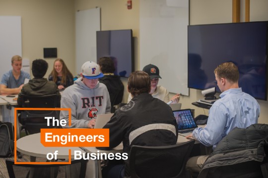 Four Saunders students study on their laptops.