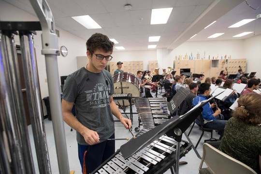 Student plays xylophone in orchestra.
