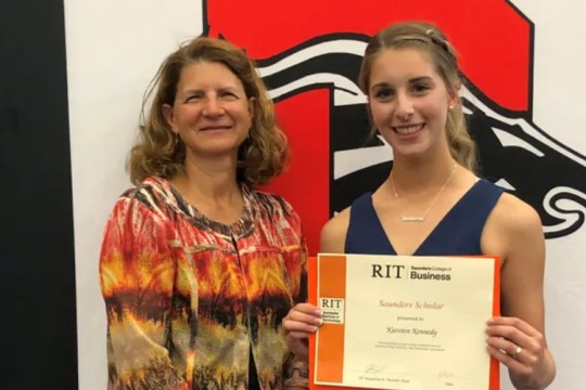 dean and student posing for photo.