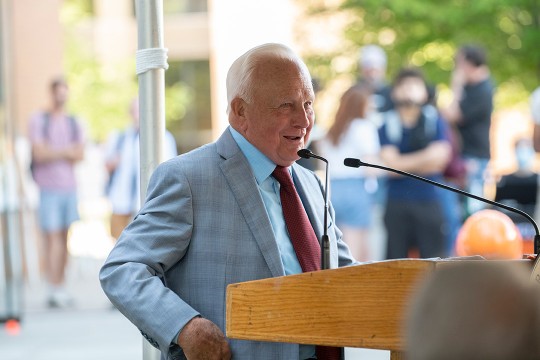 Philanthropist E. Philip Saunders speaking at a podium.