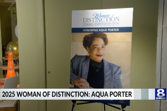 a headshot of Aqua Porter on a poster at an event.