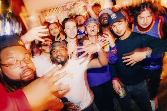 A blurred view of fans in Knicks gear celebrating.