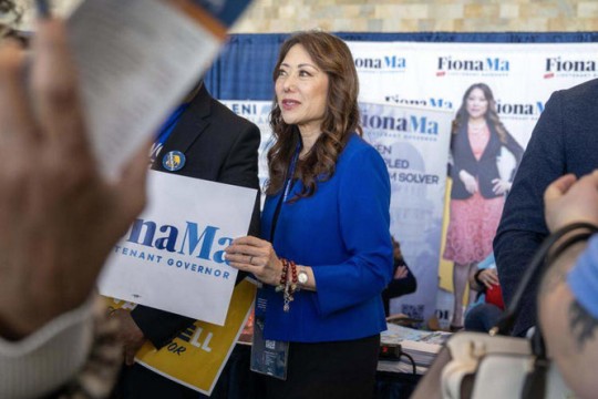 Fiona Ma, a candidate for lieutenant governor, holds a campaign sign at the California Democratic Convention in San Francisco.