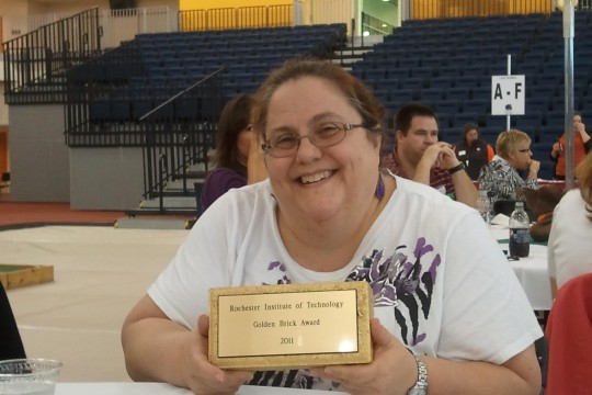 Debbie Kingsbury Holding Golden Brick Award from 2011