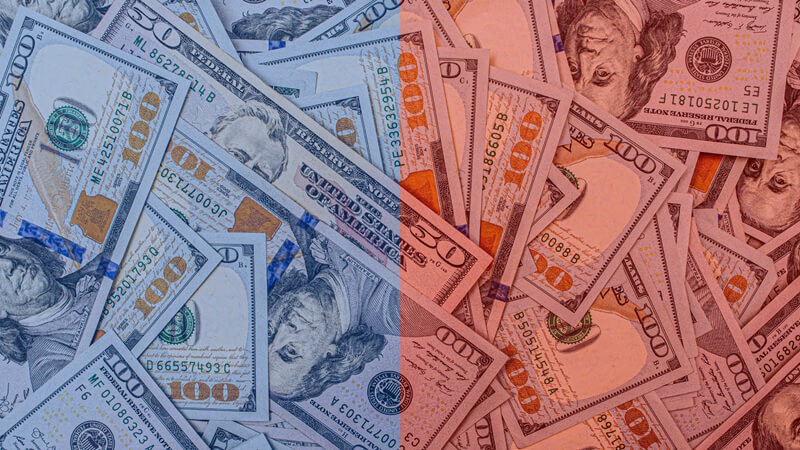 100 dollar bills, half overlayed in blue and the other half in red.