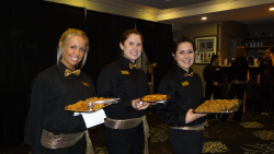 Three girls holding plates of food