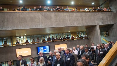 a crowd gathers in three levels of an atrium space.