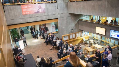 an overhead view of a crowd lining an atrium.