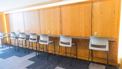 seven chairs lined up against a ledge.