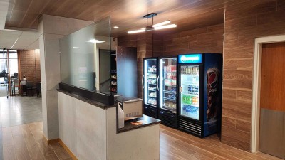 a grab and go market with a vending machine, pantry, glass doored fridge, and a microwave.
